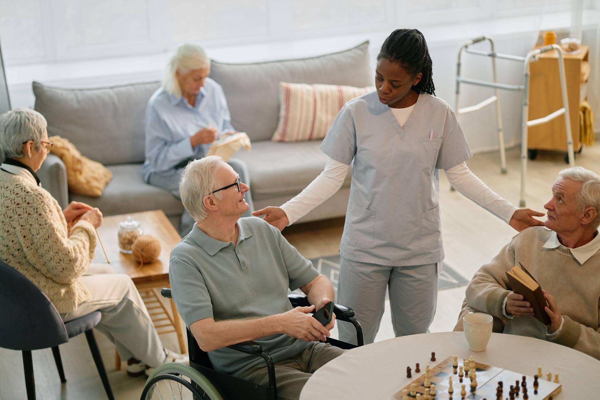 Caring Nurse Interacting with Seniors at Assisted Living Facility