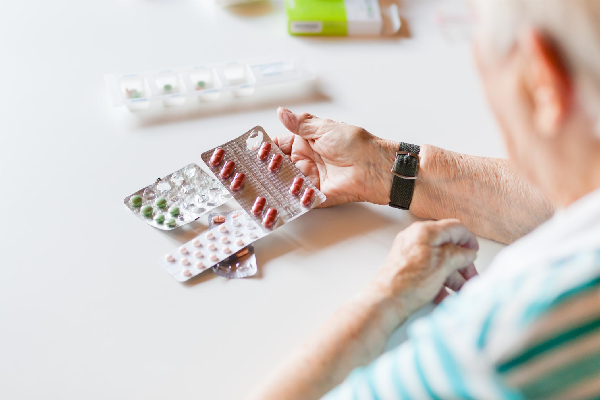 Caregiver helping a senior resident with medication and daily routines
